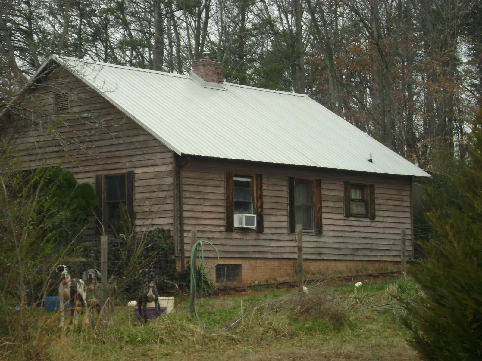 White metal roof on an old wood sided farmhouse, from a Metal Roof Installation job in Livingston Manor